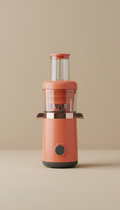 A portable juicer in 'Urban Sunrise' color, centered on a simple, neutral backdrop. The juicer's compact and lightweight...